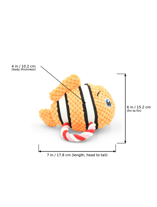 A crocheted fish-shaped dog toy with orange, black, and white stripes and a red-and-white rope tail, shown on a white background with measurement callouts indicating 7 in length, 6 in fin-to-fin length, and 4 in body thickness.
