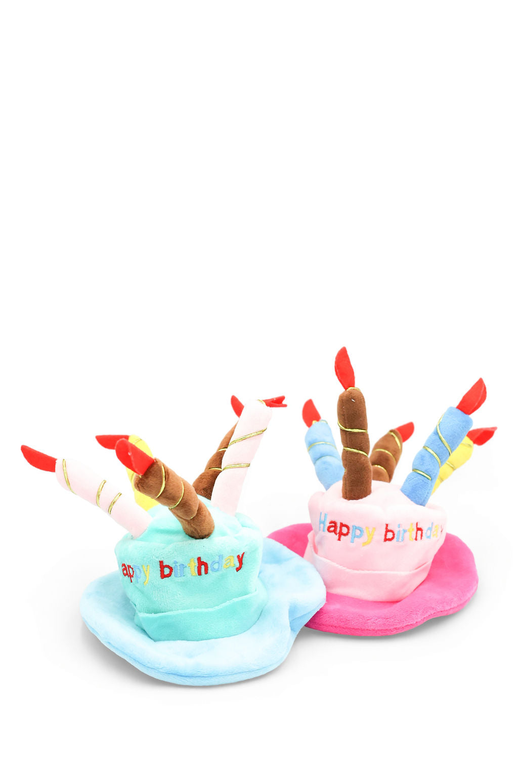 Pink and blue plush birthday cake dog toys and wearable pet hats with plush candles and "Happy Birthday" embroidered on the front.