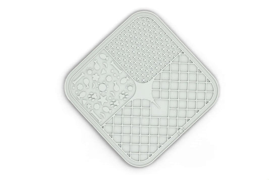 A square, diamond-shaped silicone mat with rounded corners, featuring four distinct textured quadrants: a honeycomb pattern, a moon and star motif, a grid pattern, and a central arrow design. The mat is light gray with a subtle drop shadow on a white background.