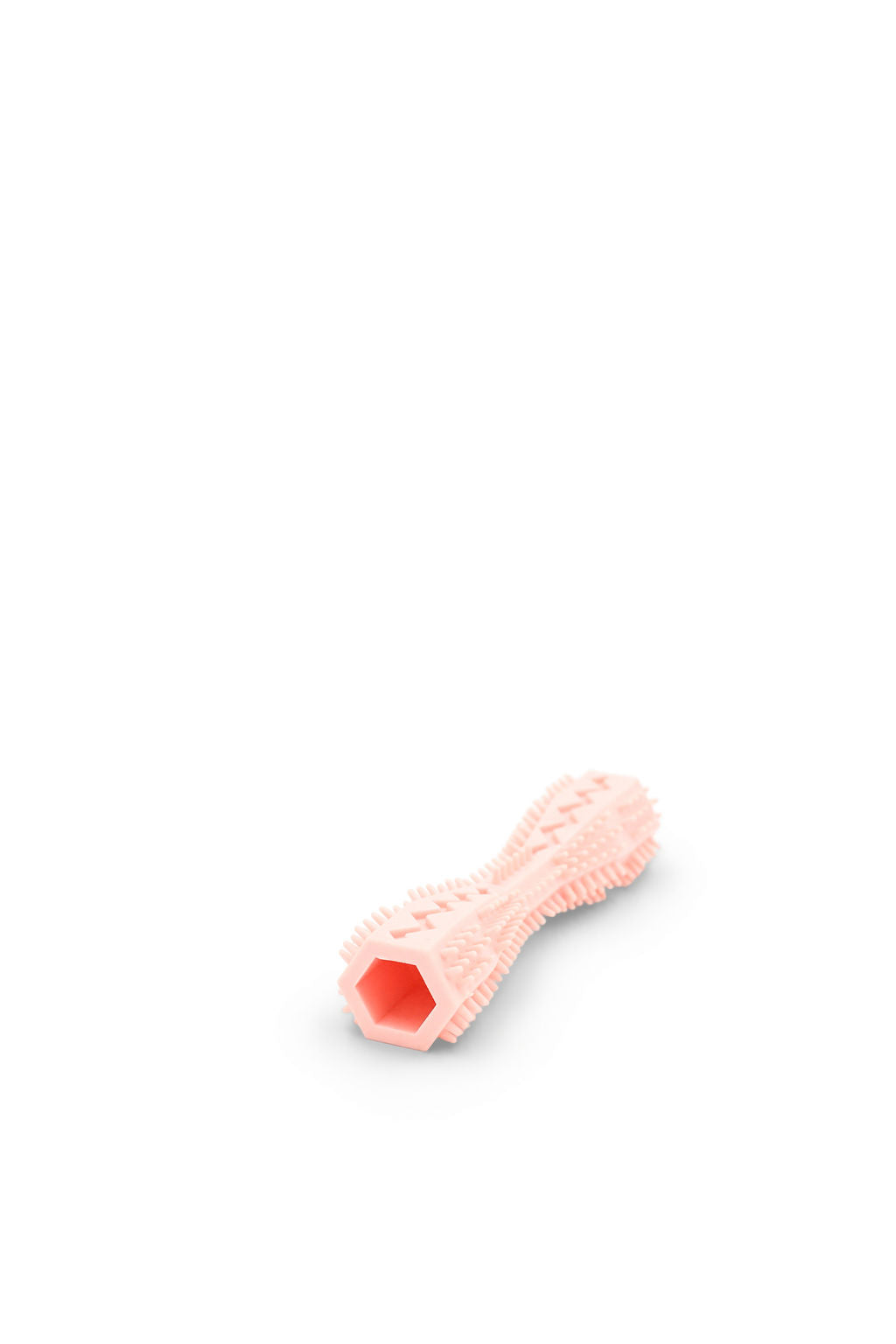Side angle view of the BudgetPaws Dog Toothbrush chew toy in Soft Petal.