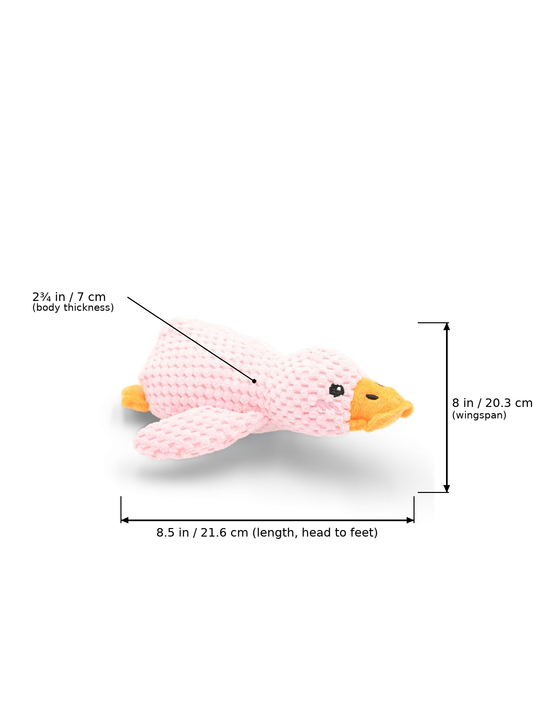 BudgetPaws Plush Duck Dog Toy | Soft Petal in Soft Petal with measurement overlay arrows indicating a length of 8.5 in / 21.6 cm (head to feet), wingspan of 8 in / 20.3 cm, and body thickness of 2¾ in / 7 cm.